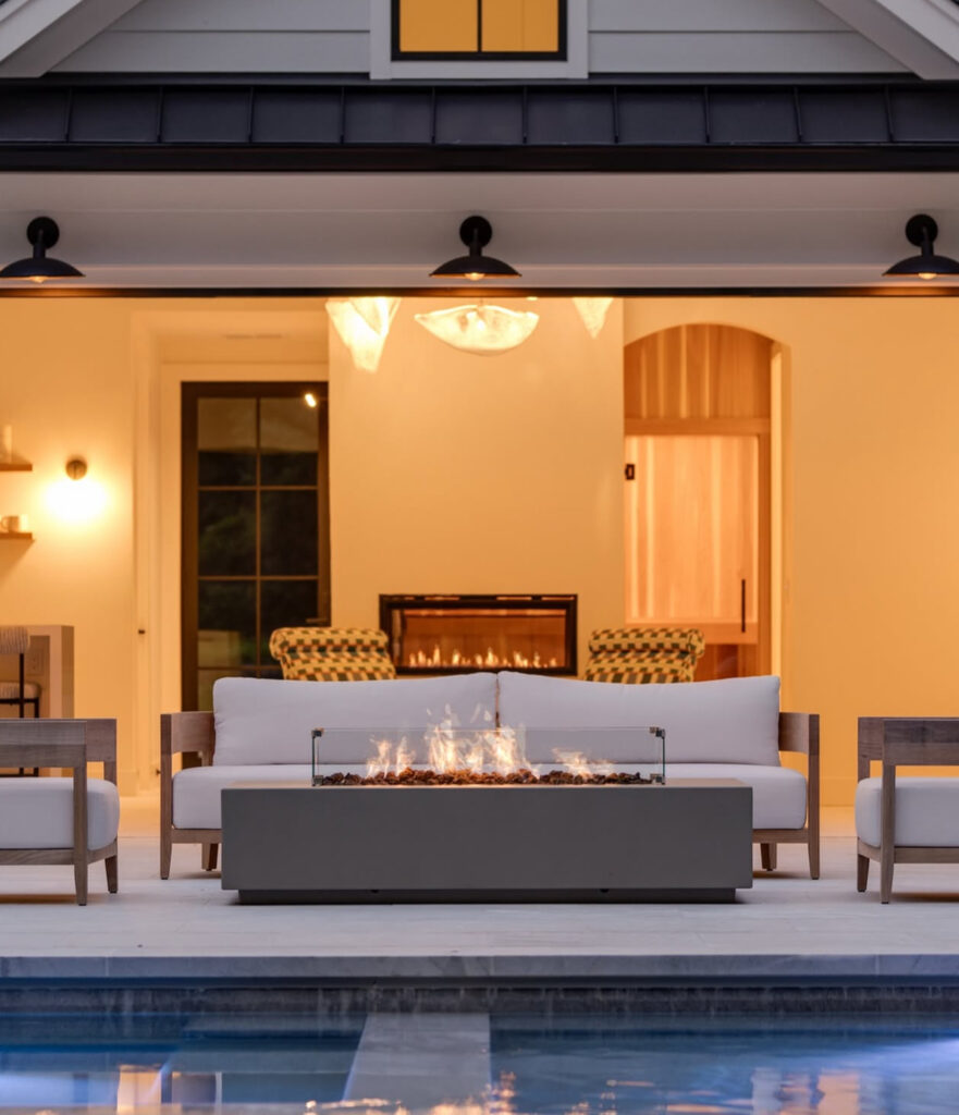 Outdoor kitchen, fire lounge, and pool house in Milton