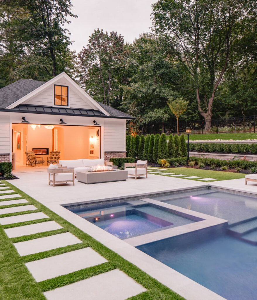 Recessed spa, pool, and pool house with stepping-stone paths
