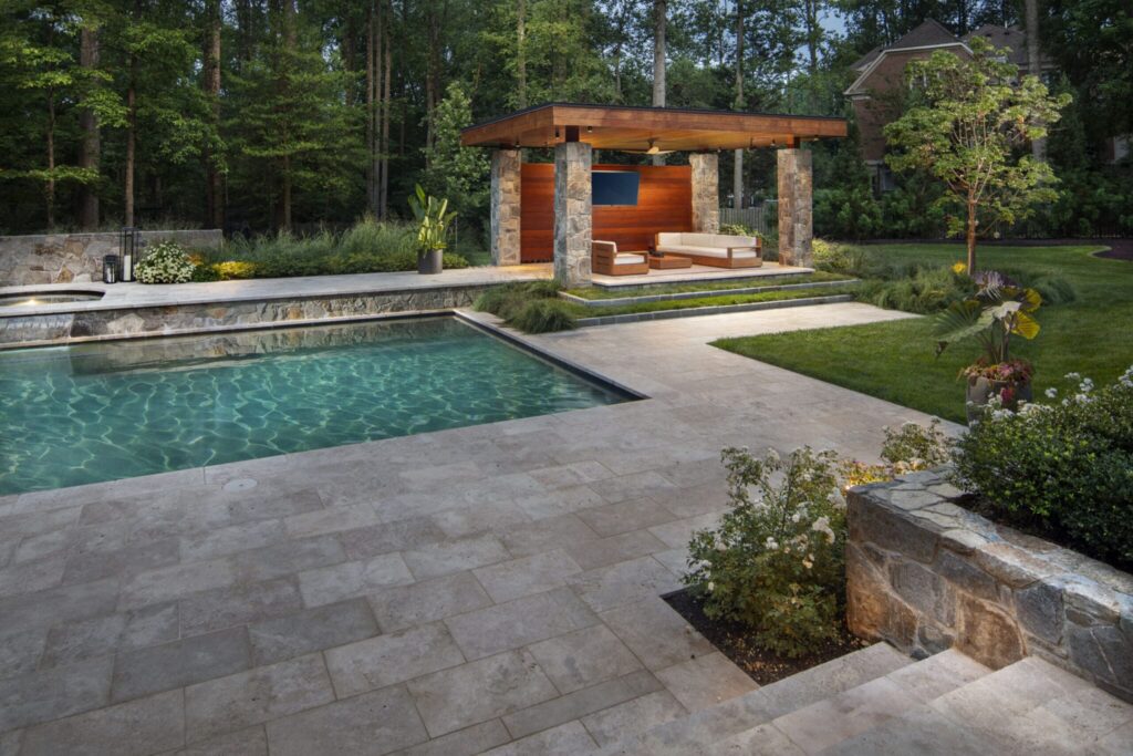 Pool terrace with a wood-and-stone pavilion and landscaped lawn
