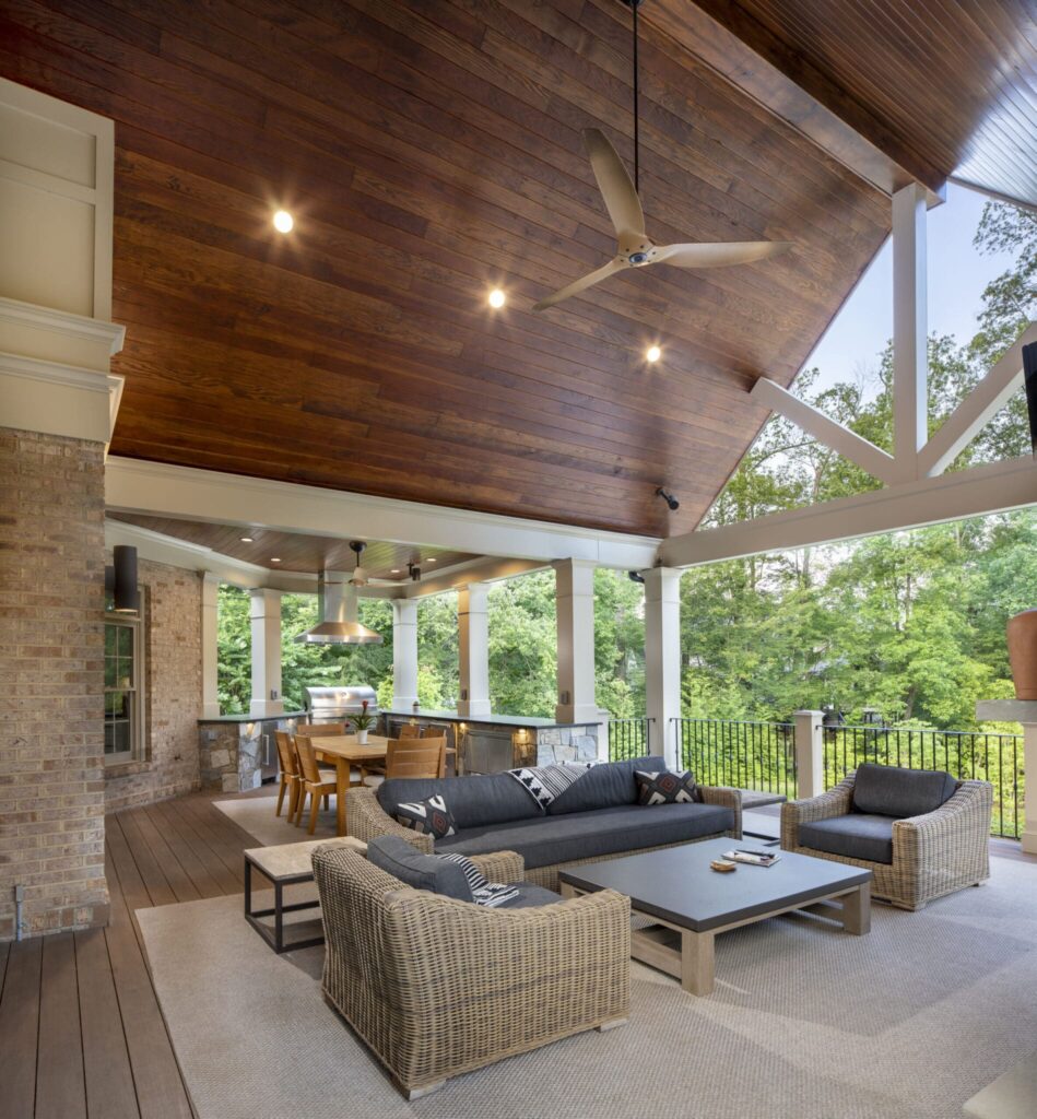 Covered outdoor living room with kitchen and vaulted wood ceiling