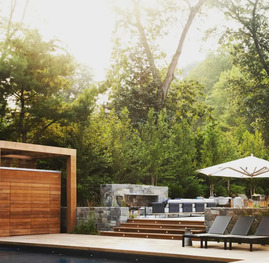 Water wall and modern pool set into a sloped Sandy Springs property